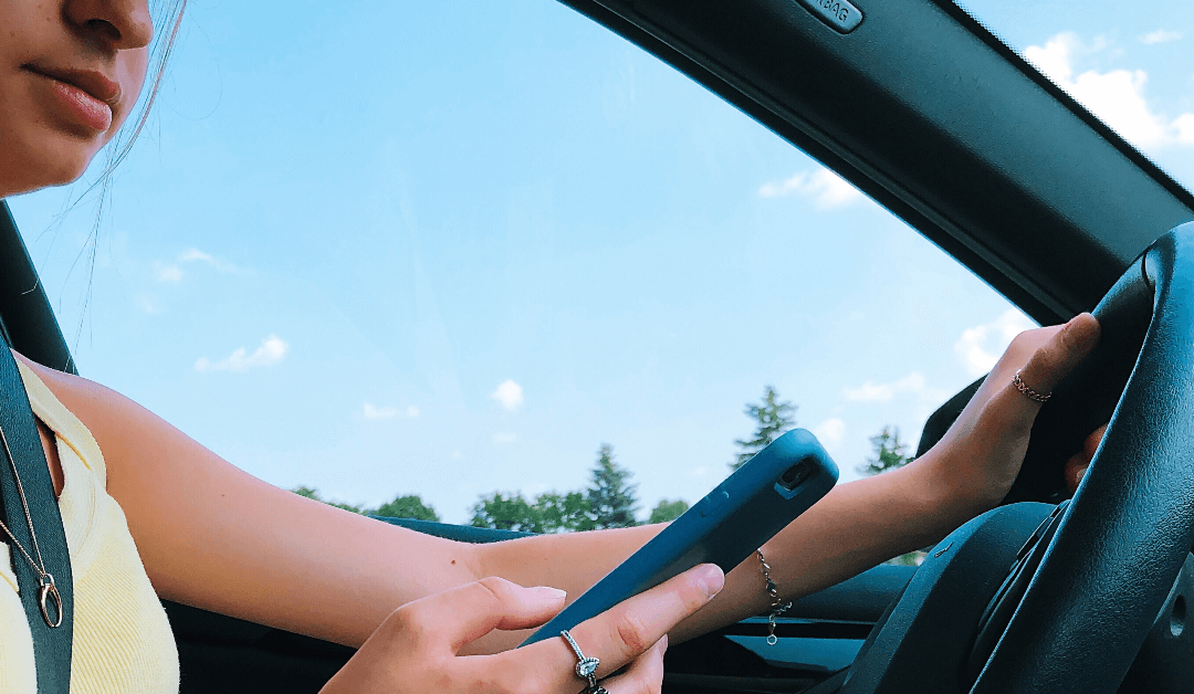 Teenage Girl Using Mobile Phone While Driving